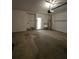 Spacious garage interior with concrete floors, utility sink, and overhead lighting at 2012 Grove Park Ct, Marietta, GA 30062