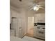 Well-lit kitchen featuring white cabinets and appliances with a ceiling fan and wood-look floors at 2012 Grove Park Ct, Marietta, GA 30062