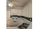Cozy kitchen with white appliances and ample countertop space with a ceiling fan at 2012 Grove Park Ct, Marietta, GA 30062