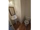 Traditional powder room with pedestal sink, decorative toilet seat and an ornate mirror at 2012 Grove Park Ct, Marietta, GA 30062