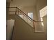 Elegant staircase with wood railings and natural light illuminating the entry at 2012 Grove Park Ct, Marietta, GA 30062