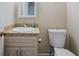 Bathroom features a vanity with granite countertop, sink, and a toilet at 4166 Rue Saint Michel, Stone Mountain, GA 30083