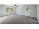Spacious carpeted bedroom features neutral walls, a ceiling fan and natural light at 4166 Rue Saint Michel, Stone Mountain, GA 30083