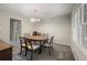 Traditional dining room features a wood table, six chairs, and a charming chandelier at 4166 Rue Saint Michel, Stone Mountain, GA 30083