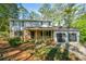 Charming two-story home featuring a brick and siding facade, covered porch, and an attached two-car garage at 4166 Rue Saint Michel, Stone Mountain, GA 30083