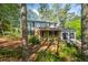 Traditional two-story home with brick and siding, a covered porch, two-car garage, and mature trees at 4166 Rue Saint Michel, Stone Mountain, GA 30083