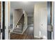 Inviting foyer with hardwood floors, staircase, coat closet, and natural light, providing a warm welcome at 4166 Rue Saint Michel, Stone Mountain, GA 30083