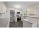 Modern kitchen features white cabinetry, stainless steel appliances, and durable gray countertops at 4166 Rue Saint Michel, Stone Mountain, GA 30083