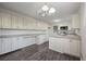 Modern kitchen with white cabinets, granite countertops and stainless steel appliances at 4166 Rue Saint Michel, Stone Mountain, GA 30083