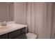 Bathroom featuring a vanity with a dark wood cabinet, white countertop, a mirror and shower at 600 Broadview Ne Ter, Atlanta, GA 30324
