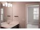 Bathroom with a large mirror, vanity, and view into the bedroom at 600 Broadview Ne Ter, Atlanta, GA 30324