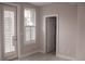 Bedroom with a door to the outside, shuttered window, and access to a closet at 600 Broadview Ne Ter, Atlanta, GA 30324