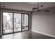 A modern bedroom with sliding glass doors opening to a balcony with seating and community views at 600 Broadview Ne Ter, Atlanta, GA 30324