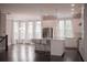 Open-concept kitchen with stainless steel appliances, granite countertops, island with seating, and hardwood floors at 600 Broadview Ne Ter, Atlanta, GA 30324