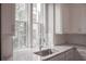 Kitchen area with stainless steel sink, granite countertops, white cabinets, and a view to the outside at 600 Broadview Ne Ter, Atlanta, GA 30324