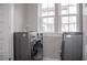 Convenient laundry room with modern washer and dryer, and a window for natural light at 600 Broadview Ne Ter, Atlanta, GA 30324