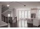Open-concept space with staircase, living room, kitchen with stainless steel appliances, granite countertops, island at 600 Broadview Ne Ter, Atlanta, GA 30324