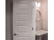 Small powder room featuring a pedestal sink, round mirror, and stylish lighting at 600 Broadview Ne Ter, Atlanta, GA 30324