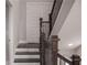 Staircase with dark wood railing and steps, white risers, leading to additional living space at 600 Broadview Ne Ter, Atlanta, GA 30324