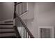 Elegant staircase featuring dark wood steps and black iron railing at 600 Broadview Ne Ter, Atlanta, GA 30324