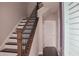 Stylish staircase with dark wood steps, white risers, and iron railing leading to upper floors at 600 Broadview Ne Ter, Atlanta, GA 30324