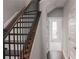 View of staircase with wood steps, iron railings, and white walls at 600 Broadview Ne Ter, Atlanta, GA 30324