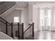 Staircase with dark wood railings, hardwood treads, and neutral walls offers an elegant transition between levels at 600 Broadview Ne Ter, Atlanta, GA 30324