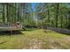 Expansive backyard with lush greenery, a deck, and plenty of space for outdoor entertaining at 3076 Nectar Dr, Powder Springs, GA 30127