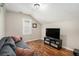 Upstairs bonus space featuring recessed lights, wood-look floors, and a comfortable sofa at 3076 Nectar Dr, Powder Springs, GA 30127