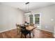 Cozy dining room with a wooden table, French doors, and stylish lighting at 3076 Nectar Dr, Powder Springs, GA 30127