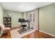 Home office area featuring natural light, a rolling desk, and wood-look floors at 3076 Nectar Dr, Powder Springs, GA 30127