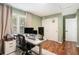 Bright home office space with natural light, a rolling desk, and wood-look floors at 3076 Nectar Dr, Powder Springs, GA 30127