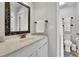 Bright bathroom with a marble countertop vanity and decorative framed mirror at 1021 Windy Oaks Se Ct, Smyrna, GA 30080