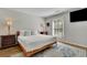 Comfortable bedroom with large window, wood floors and neutral decor at 1021 Windy Oaks Se Ct, Smyrna, GA 30080