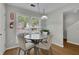 Cozy dining area featuring a modern table and chairs, with natural light at 1021 Windy Oaks Se Ct, Smyrna, GA 30080