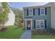Charming two-story townhouse featuring light-green siding, black shutters, and a well-maintained front lawn at 1021 Windy Oaks Se Ct, Smyrna, GA 30080