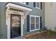 Inviting front entrance with updated lighting, and glass storm door, offering a welcoming and modern aesthetic at 1021 Windy Oaks Se Ct, Smyrna, GA 30080