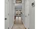 Bright hallway featuring multiple doors, light gray paint, and hardwood flooring at 1021 Windy Oaks Se Ct, Smyrna, GA 30080