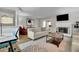 Bright living room with a fireplace, light furniture, and a comfortable workspace at 1021 Windy Oaks Se Ct, Smyrna, GA 30080