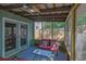 Inviting screened-in porch with comfortable furniture and a view of the backyard at 1021 Windy Oaks Se Ct, Smyrna, GA 30080