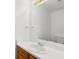 White bathroom features a single vanity and gold fixtures at 2181 Poplar Grove Ct, Snellville, GA 30078