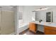 Large bathroom with soaking tub, double sink vanity, and glass enclosed shower and dark hardwood floors at 2181 Poplar Grove Ct, Snellville, GA 30078