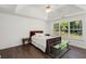Bright bedroom with a trey ceiling, dark hardwood floors, a ceiling fan, and large window at 2181 Poplar Grove Ct, Snellville, GA 30078
