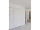 Bedroom with a large closet featuring bi-fold doors and an open doorway at 2181 Poplar Grove Ct, Snellville, GA 30078