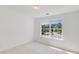 Bright bedroom with a large window offering a scenic neighborhood view at 2181 Poplar Grove Ct, Snellville, GA 30078