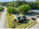 A community pool house and tennis courts sit on a lush green lawn surrounded by trees in the neighborhood at 2181 Poplar Grove Ct, Snellville, GA 30078