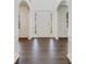 Bright foyer featuring elegant archways, hardwood floors, and a welcoming entrance at 2181 Poplar Grove Ct, Snellville, GA 30078