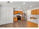Well-equipped kitchen with stainless steel appliances, wood cabinets, and modern finishes at 2181 Poplar Grove Ct, Snellville, GA 30078