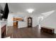 Open floor plan living room featuring hardwood floors, fireplace and view to kitchen at 2181 Poplar Grove Ct, Snellville, GA 30078