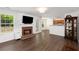 Cozy living room with brick fireplace, dark hardwood floors, and plenty of natural light at 2181 Poplar Grove Ct, Snellville, GA 30078
